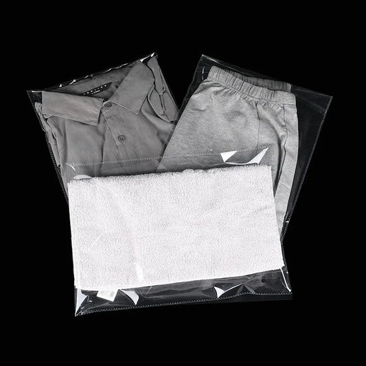 StoBag 100 bolsas autoadhesivas transparentes para ropa – Bolsas de plástico transparentes para embalaje de ropa con cierre adhesivo para camisetas, regalos, bodas y fiestas