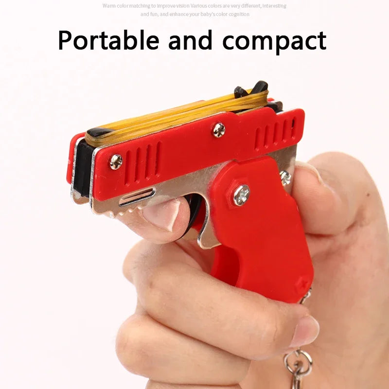 Llavero de pistola de goma de metal - Mini pistola de juguete de aleación con 60 gomas elásticas para juegos al aire libre, diversión en fiestas y regalos