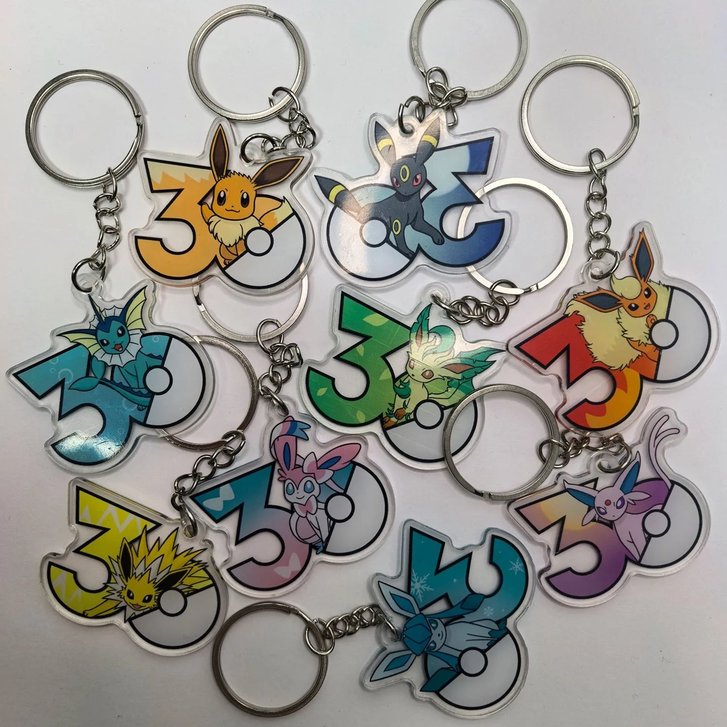 Pokémon 30th Anniversary Acrylic Keychain – Captain Pikachu, Eevee & Eeveelutions (50 Styles)